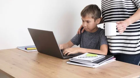 Kid homework with laptop computer. Parents support Vídeo Stock 128425942