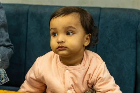 Kid innocent face expression sitting at sofa at night 写真素材