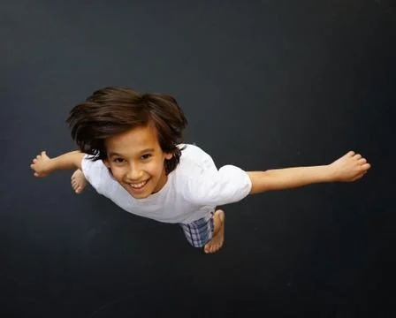 Kid jumping high up Stock-Fotos