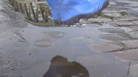 A Kid Jumping in a Puddle Stock Footage 58858088