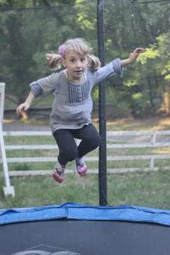 Kid jumping on tramboline Stock Photos
