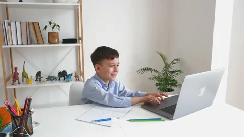 Kid via laptop talking with teacher during online studying at home Stock Footage 150731421