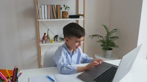 Kid via laptop talking with teacher during online studying at home Stock Footage 150747973