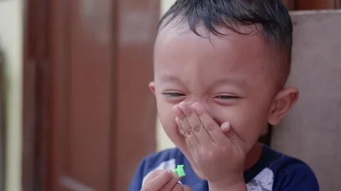 Kid Laughing, Little Asian Boy Laughs and show funny expression Stock Footage
