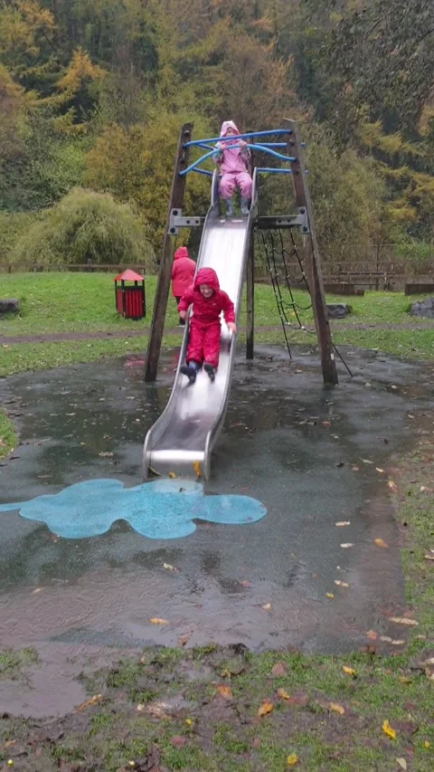 Kid Laughs off a Face Full of Mud after Fun Trip Down the Slide - 28 Oct 2020 Stock Footage 205330413