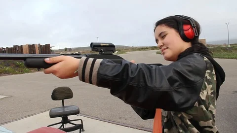 Kid learning how to aim gun Stock Footage 113912058
