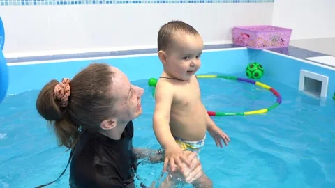 Kid is learning to swim and floating. Indoor view. Slow motion, training. Stock Footage 175374560