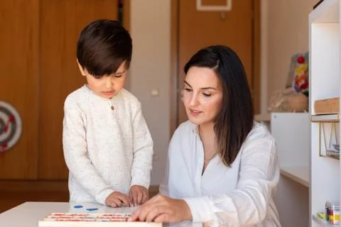 Kid learning to write and read with a alphabet and mother or teacher help. Ho Stock Photos