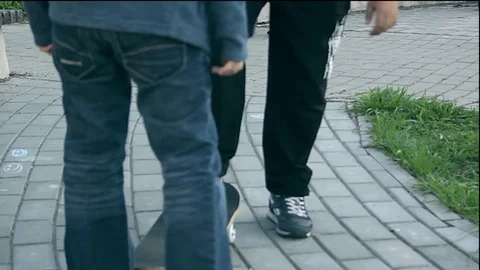 Kid learns skateboard Stock Footage 75660199