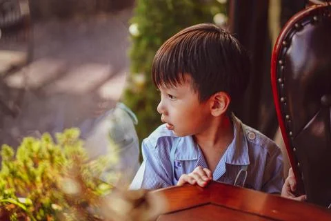 Kid looking out window.  Фото