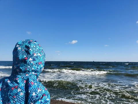 Kid looking at the sea, missing parents Stock Photos