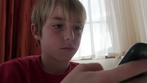 Kid looking at smartphone during breakfast. Stock Footage 168613053