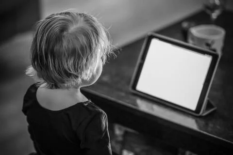 Kid looking at tablet at the night Stock Photos