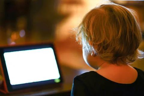 Kid looking at tablet at the night Stock Photos