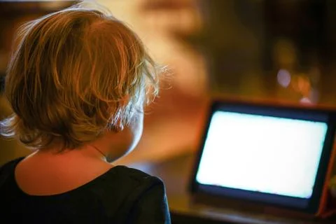 Kid looking at tablet at the night Stock Photos