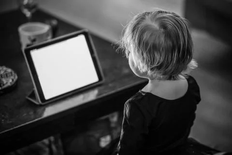 Kid looking at tablet at the night Stock Photos