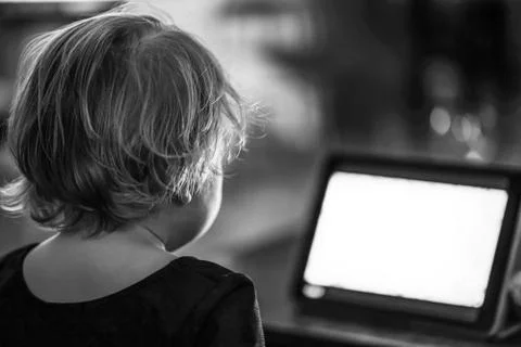 Kid looking at tablet at the night Stock Photos