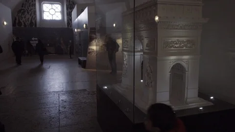 Kid looking through glass at Arc de Triomphe model inside museum - display Paris Stock Footage 93813261