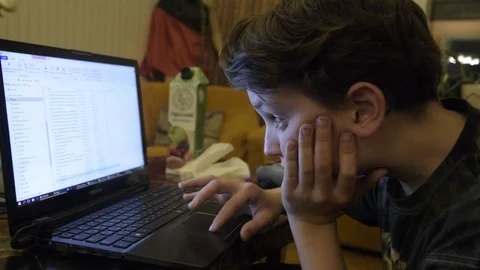 Kid looks at a laptop screen Stock Footage 102379754