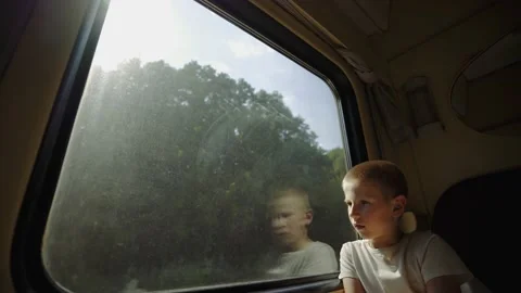 Kid looks out the train window. View of nature from the train compartment. Stock-Footage 149240832