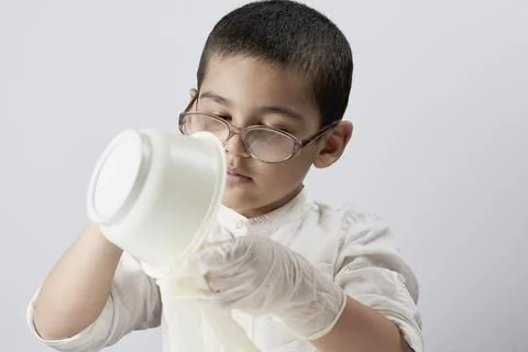 A kid making experiments at home Stock Photos