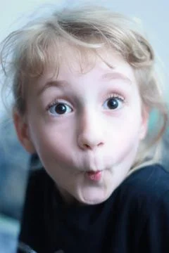 Kid making funny face Stock Photos