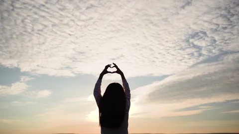 Kid making heart hands against the blue sky, child Stock Footage 236257252