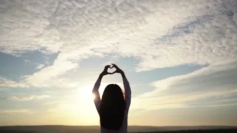 Kid making heart hands against the blue sky, child Stock Footage 236257280