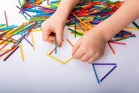 Kid making rectangular and triangle shape as creative concept Stockfoto's