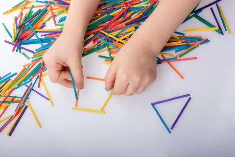 Kid making rectangular and triangle shape as creative concept Stock Photos