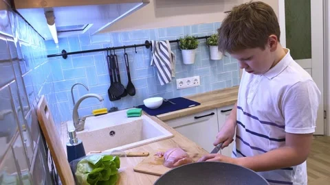 A kid is making shawarma and hot dogs inside pita bread Stock Footage 309947398
