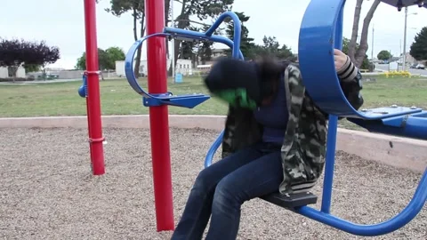 Kid in mask messing around on playground Stock Footage 155490983