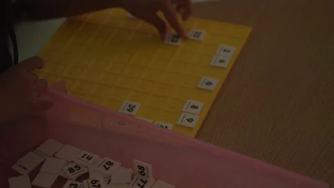 KID MATCHING NUMBERS ON GAME BOARD Stock Footage 94428271