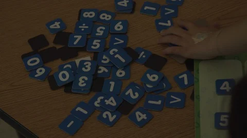 KID MESSING WITH PAPER NUMBERS Stock Footage 94428109