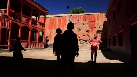 Kid monks playing outside the monastery in Mustang, Nepal Stock Footage 62924019
