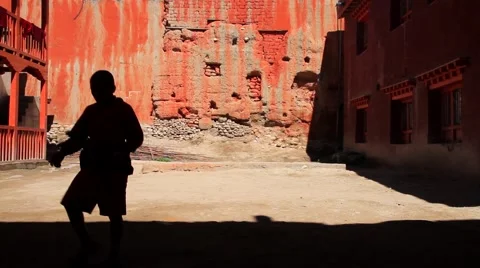 Kid monks playing outside the monastery in Mustang, Nepal Video stock 62924027