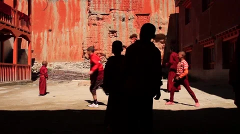 Kid monks playing outside the monastery in Mustang, Nepal Stock Footage 62924029