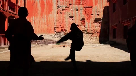 Kid monks playing outside the monastery in Mustang, Nepal Stock Footage 62924035
