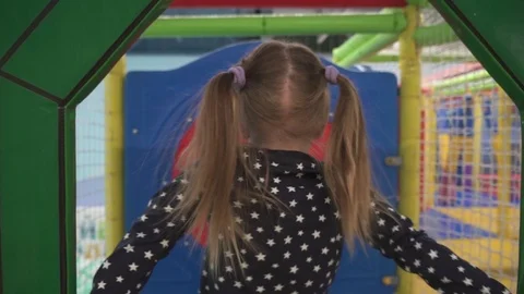 Kid moves through maze on children's obstacle course at playground Stock Footage 102269019