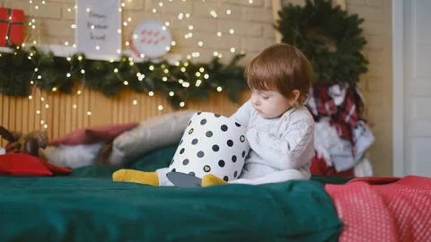 The kid opens a Christmas present. Happy childhood. Merry Cristmas. Stock Footage 144293696