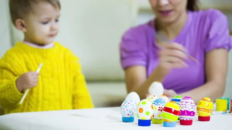 Kid painting Easter eggs with  mother Stock Footage 60820864