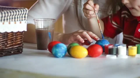 Kid painting Easter eggs with their mother Stock Footage 48426882