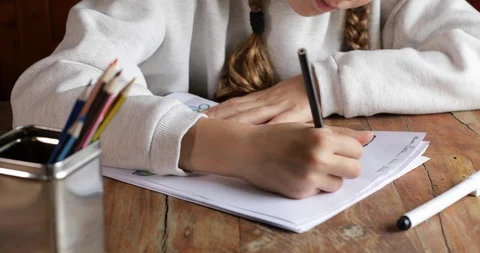 Kid paints her homework Video stock 128320717