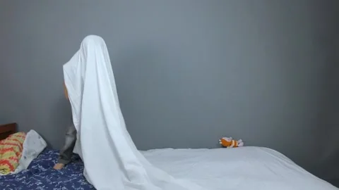 Kid playing and jumping on a gray background Stock Footage 132663841