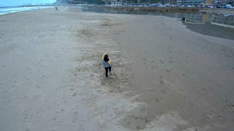 Kid playing on the beach. Aerial shoot Stock Footage 86696460