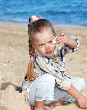 Kid playing on beach. Stock Photos