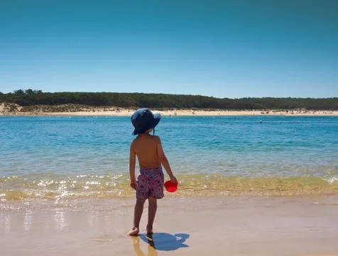 Kid playing on the beach Stock Photos