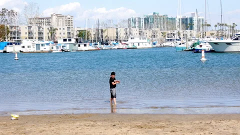 A kid playing at the beach with the sand Stock Footage 237045226