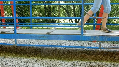 Kid playing on a big blue swing at the park Video stock 78827271