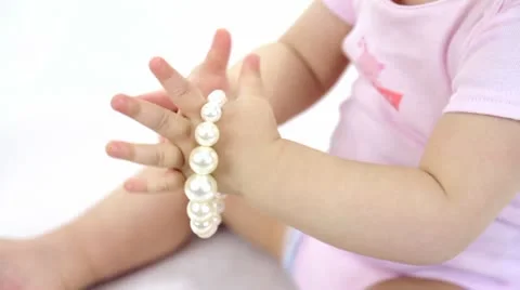 Kid playing bracelet Stock-Footage 21845897